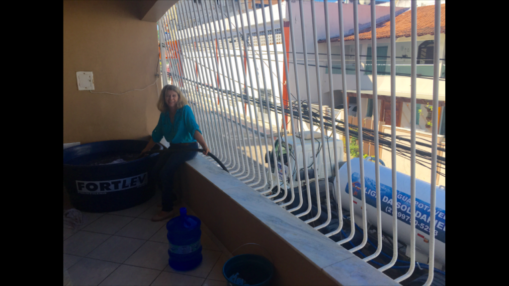 Madalena filling the container with fresh (FRESH) water